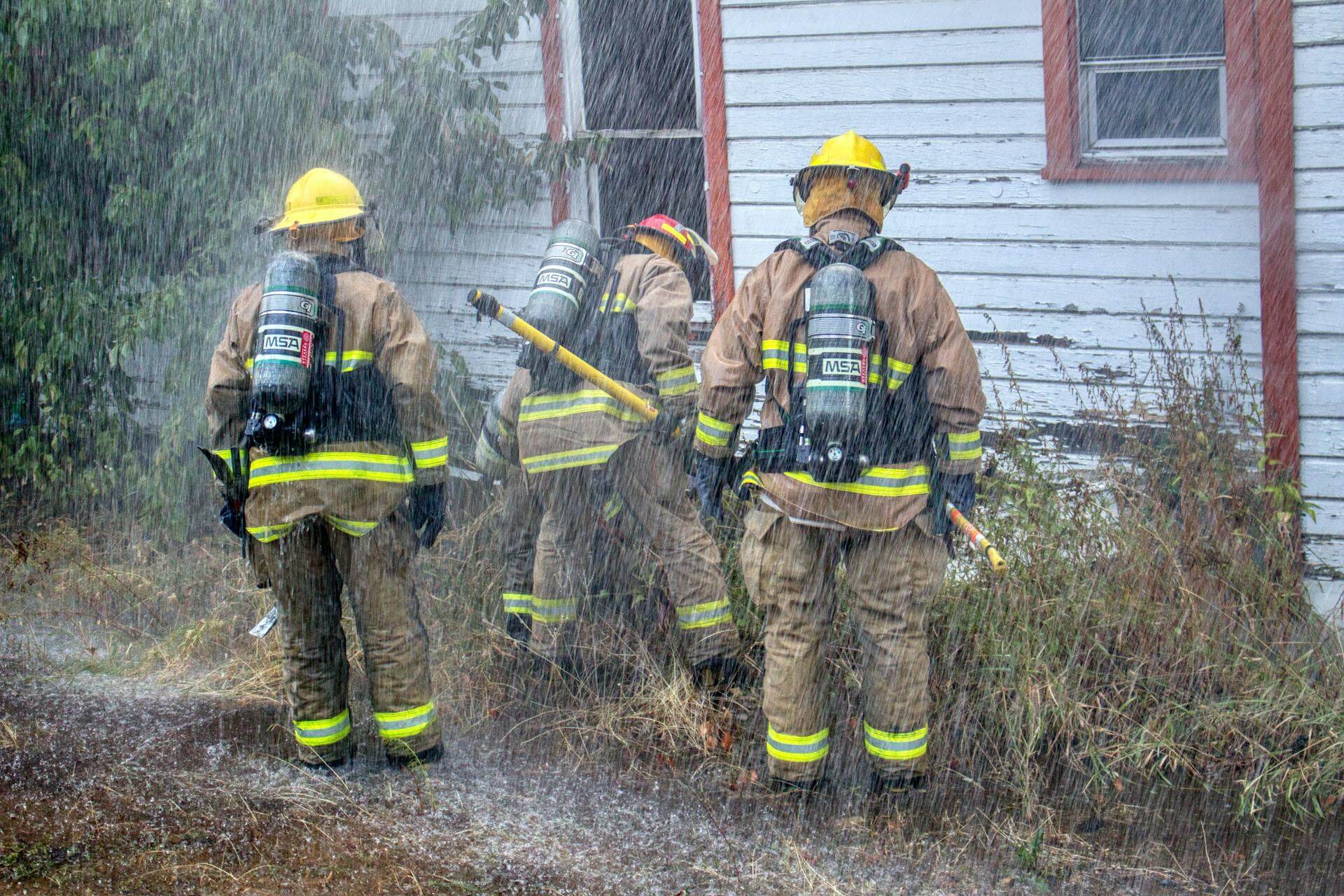 House Fire in Rain with Firefighters