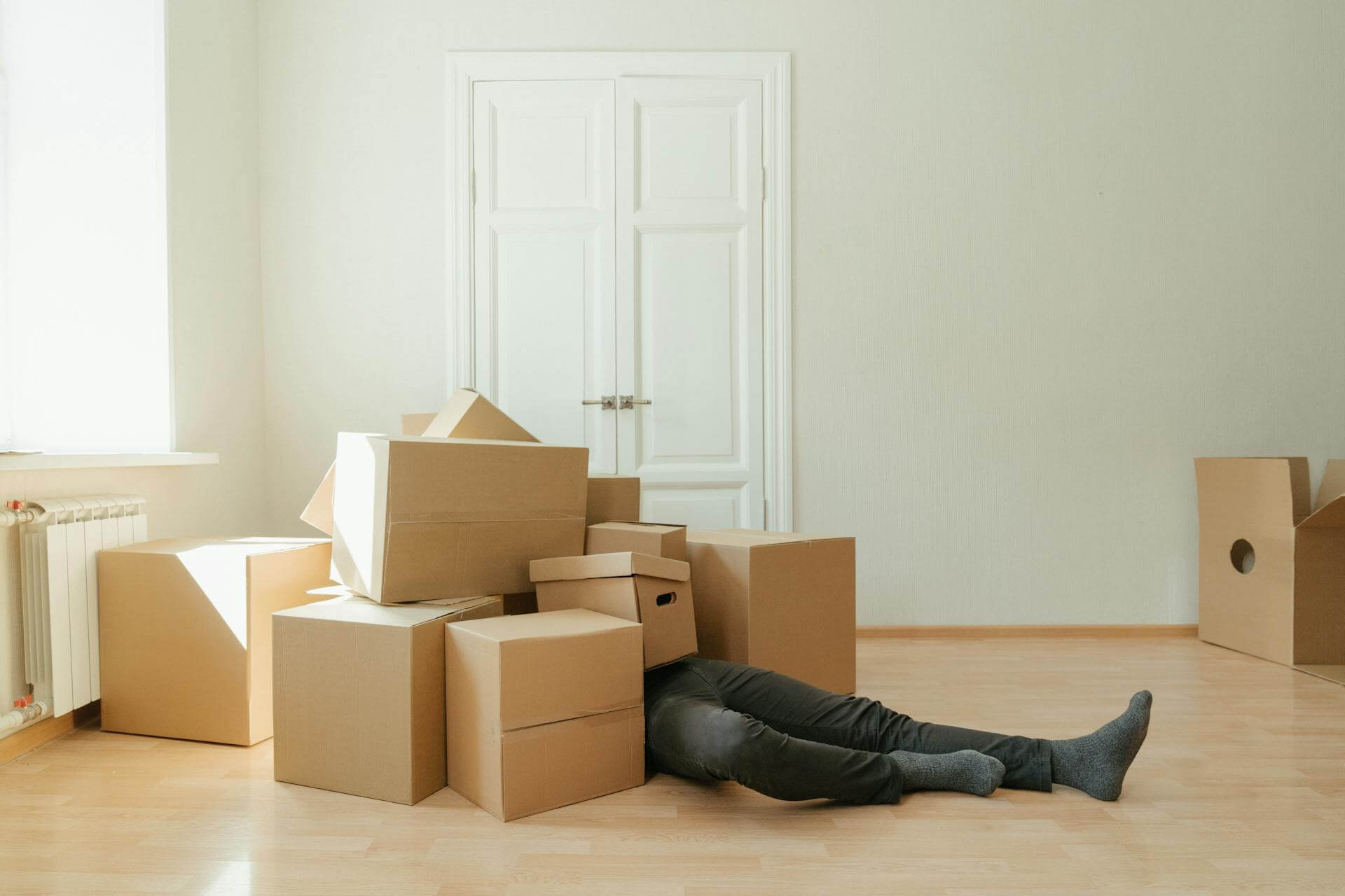 Man Lying on Floor with Boxes