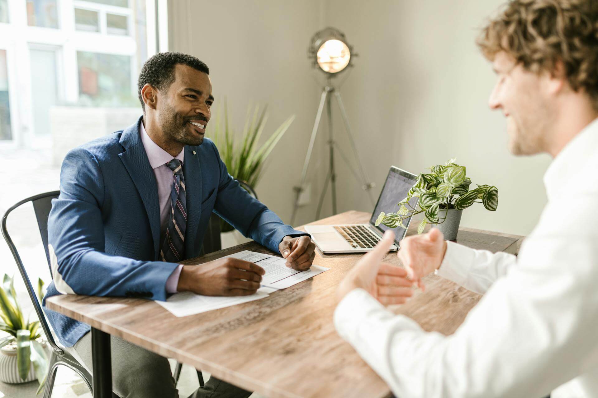 Men Sitting at Table Smiling Insurance Company